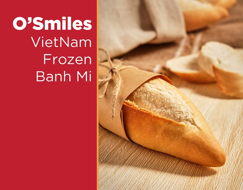 Frozen banh mi wrapped in paper on a wooden board