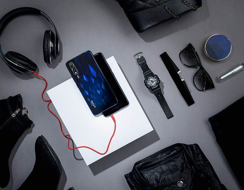 VIVO S1 phone flat-lay surrounded by black accessories on grey